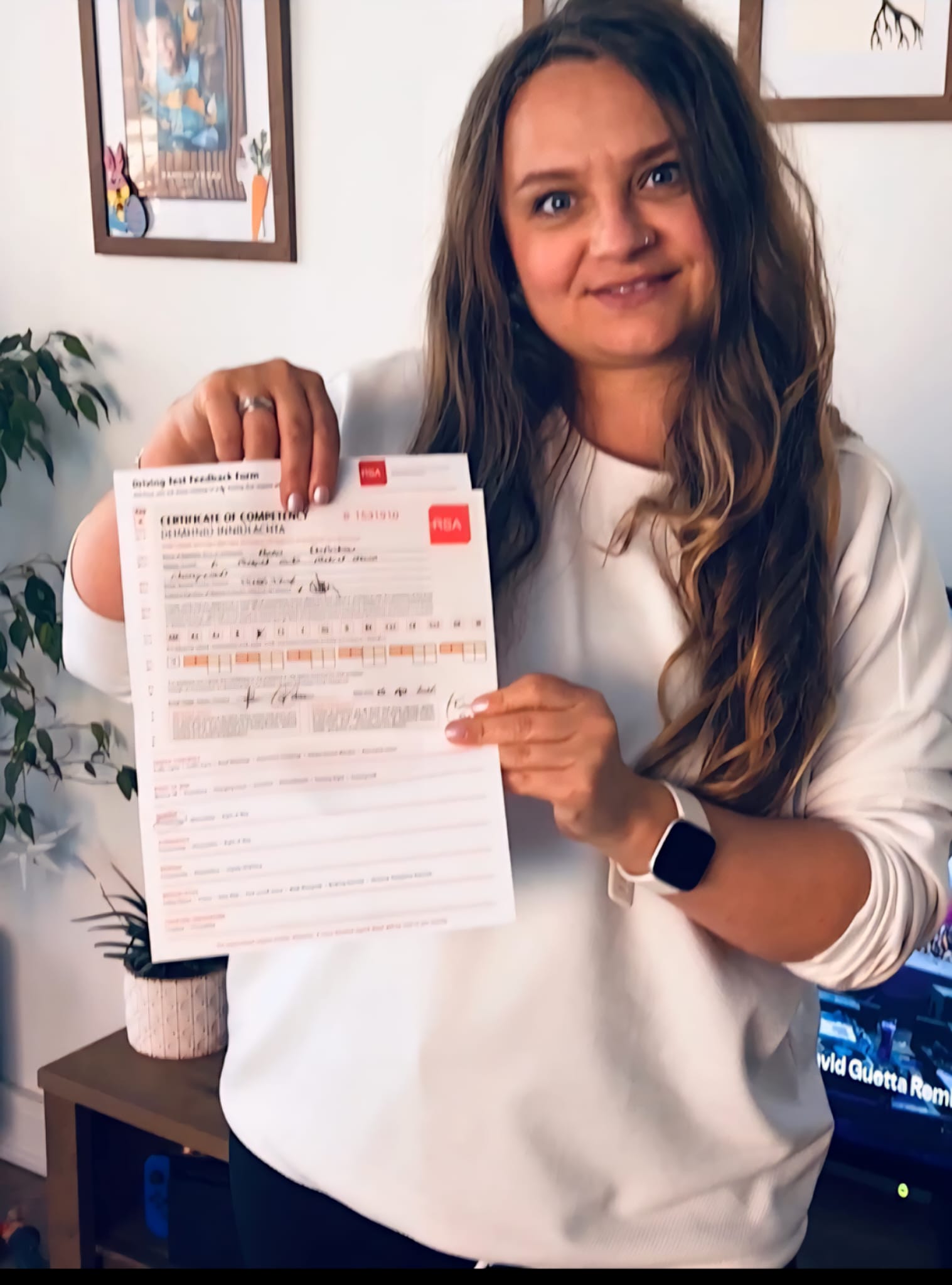 Student proudly showing her RSA Certificate of Competency