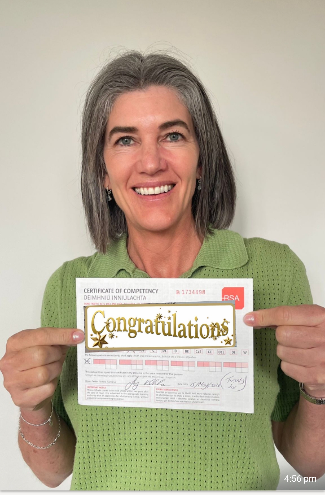 Student beaming with her Certificate of Competency